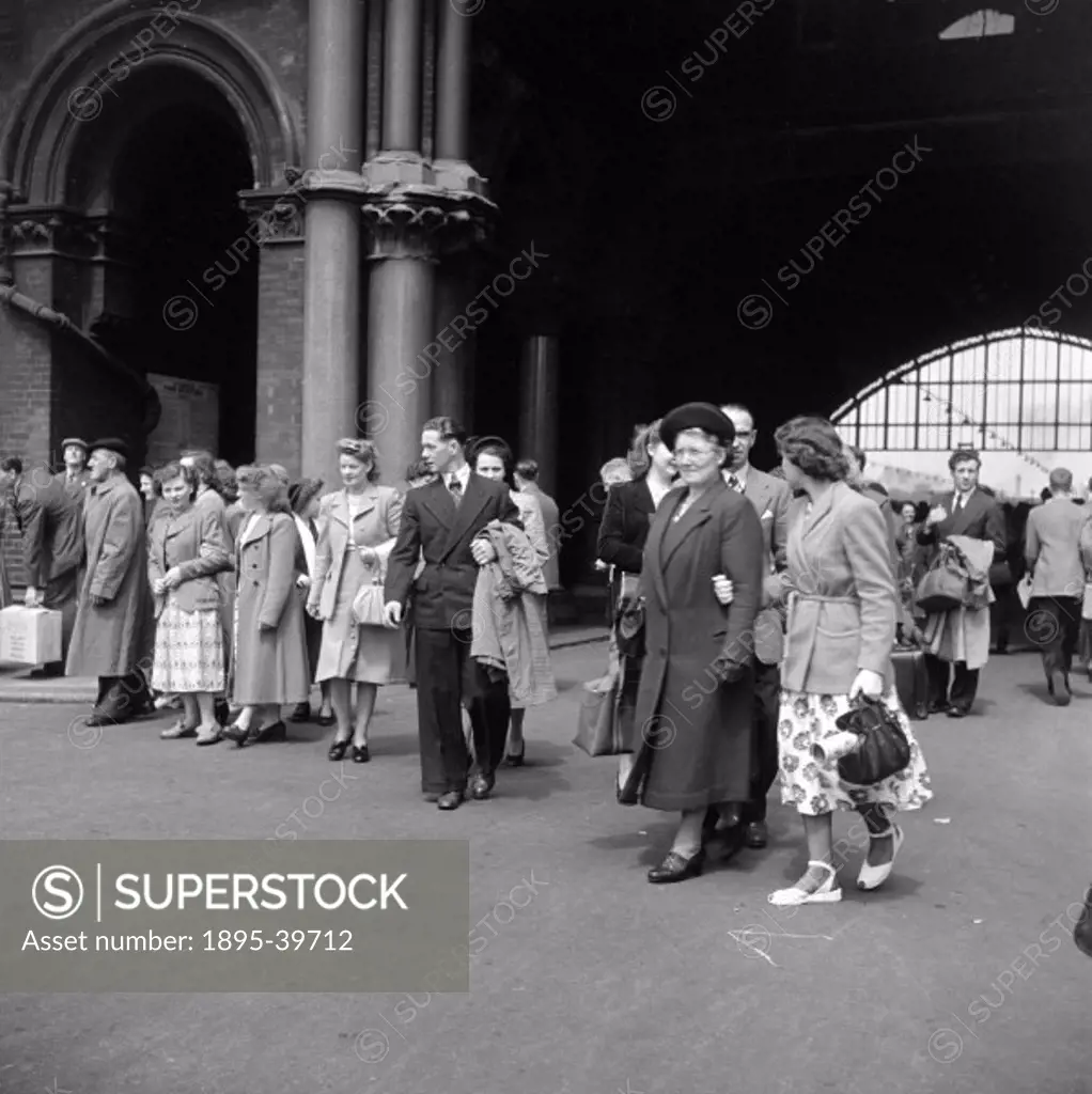 Group of tourists in London St Pancras station, 1950.  These people are in a party of workers from a boot factory in Leicester going to London for a d...