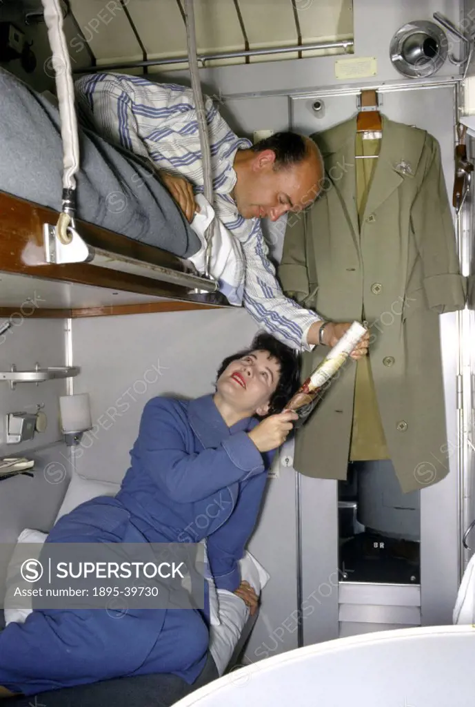 Sleeping compartment in a train, 1962. These passengers are in a train which transported both passengers and their cars, so that people could go on ho...