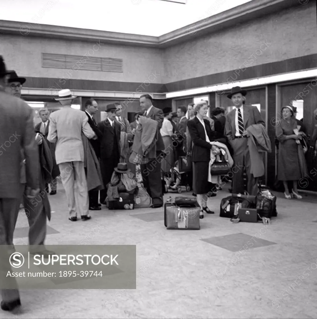 Passengers inside the ticket office in Ocean terminal at Southampton Docks, 1950.   This terminal is where people arrived to take ocean liners to the ...