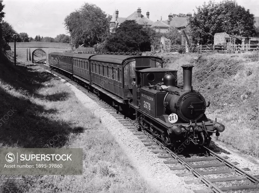 An 0-6-0T locomotive number 2678 with a local train near Hayling Island, Hampshire, by Godfrey Soole, about 1937.  The train is hauled by a tank engin...
