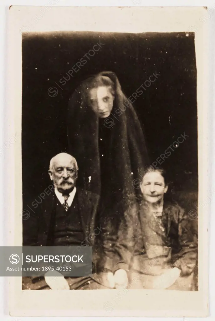 A portrait photograph possibly taken by William Hope (1863-1933). A young woman´s face appears as if floating above the sitters, draped in a cloak. Ho...