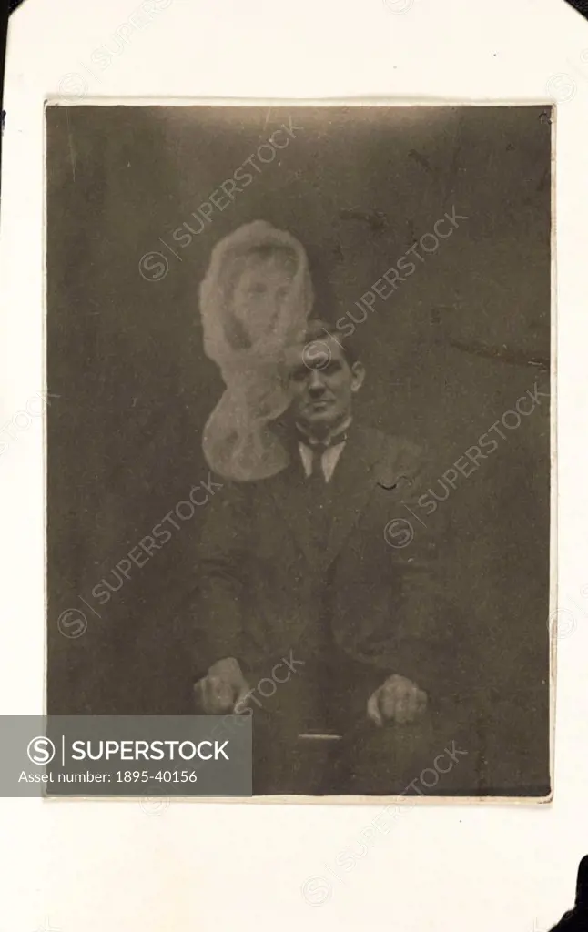 A photograph of the Welsh medium Joe Thomas, taken by William Hope (1863-1933). The shrouded woman´s face appearing in the photograph was not identifi...