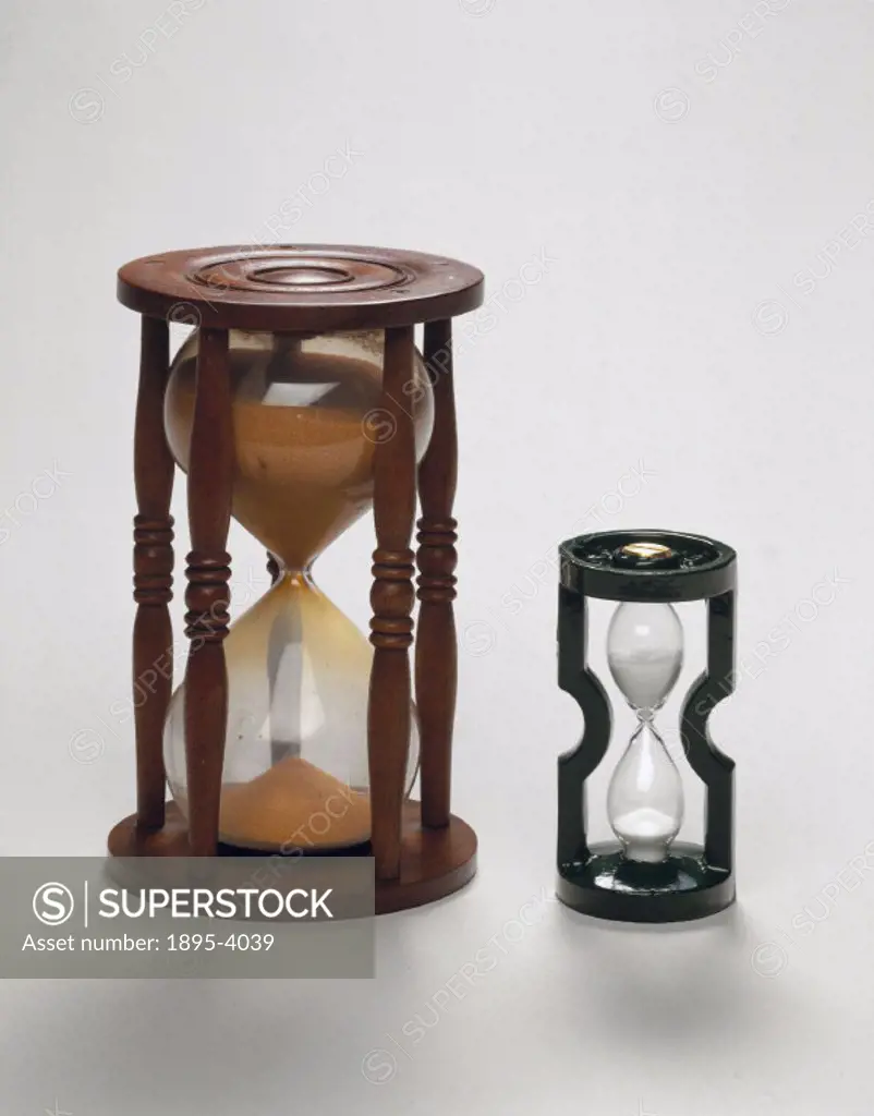 The hour glass on the left is the final form of the sand glass, a one-piece glass bulb sealed after filling with sand, which was introduced in the ear...