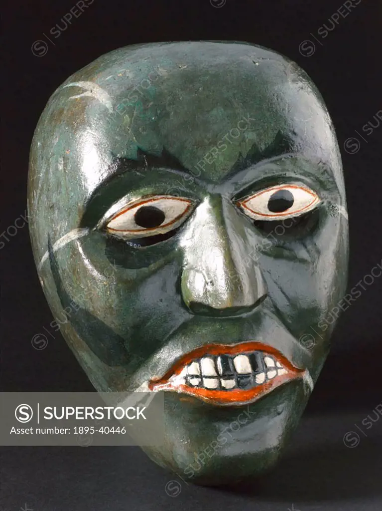 Singhalese wooden disease mask in the form of a human face, worn for healing rituals.