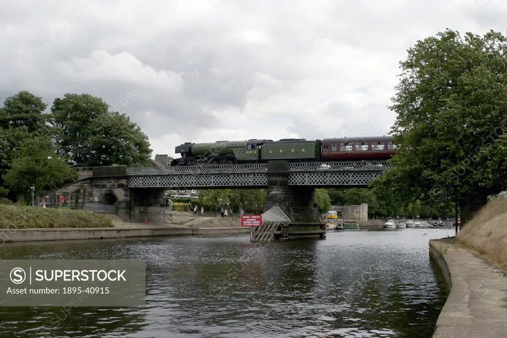 LNER steam locomotive 4-6-2 No 4472 Flying Scotsman’ crossing Scarborough bridge that spans the River Ouse at York, on route to Scarborough. The Flyi...