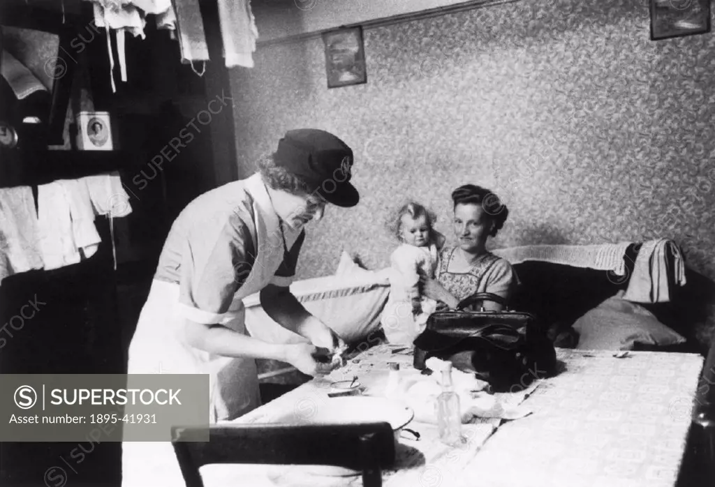 District nurse attending a sick child, November 1955.
