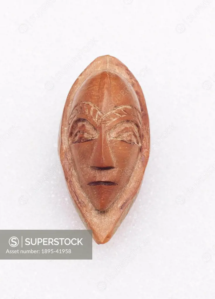 Amulet in the form of a human face, carved out of a fruit stone, made by the Bushongo tribe of Zaire.