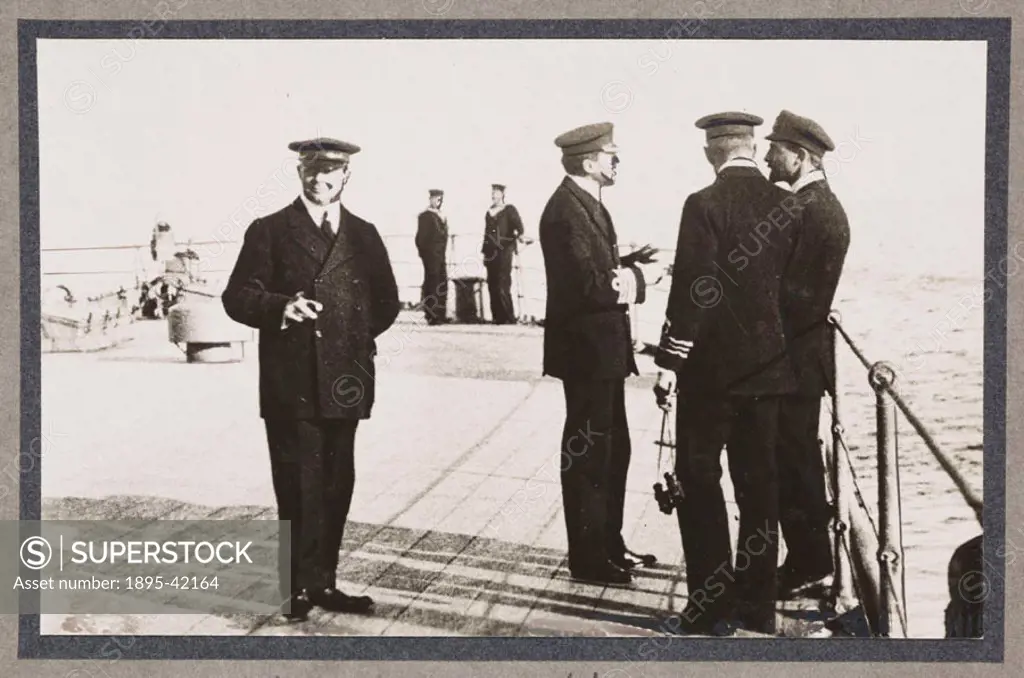 A photograph of British naval officers stood talking on the deck of HMS Queen Elizabeth,  taken by an unknown photographer in about 1916. This photogr...