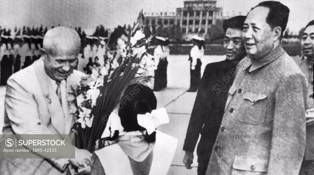 Thank-you smile from Khrushchev as he receives a bouquet. Watching, in tunic jacket, is Mao Tse-tung’. In 1959 there was a break in relations between...