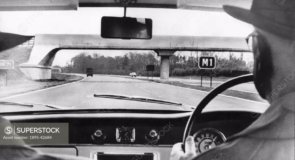 View through a car windscreen showing the M1 motorway shortly after opening. The motorway cost £23,000,000 to build.