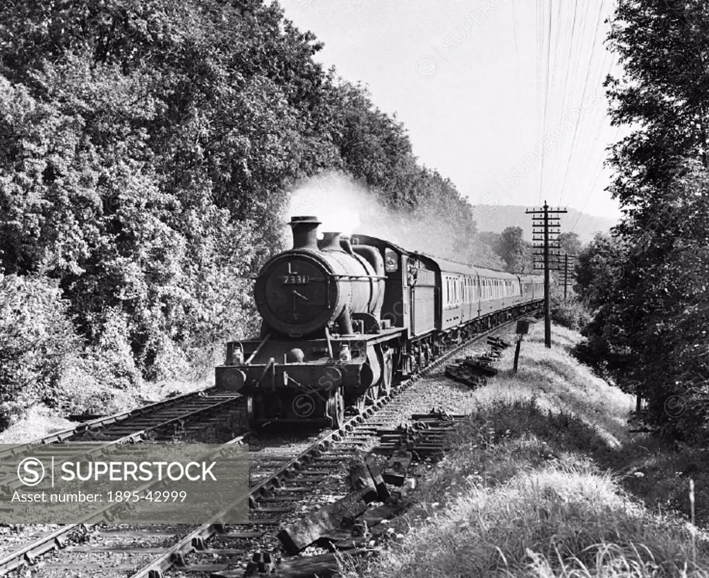 A 4300 class 2-6-0 No 7331 heads a passenger train beside the north downs near Betchworth. Photograph by Colin T Gifford.