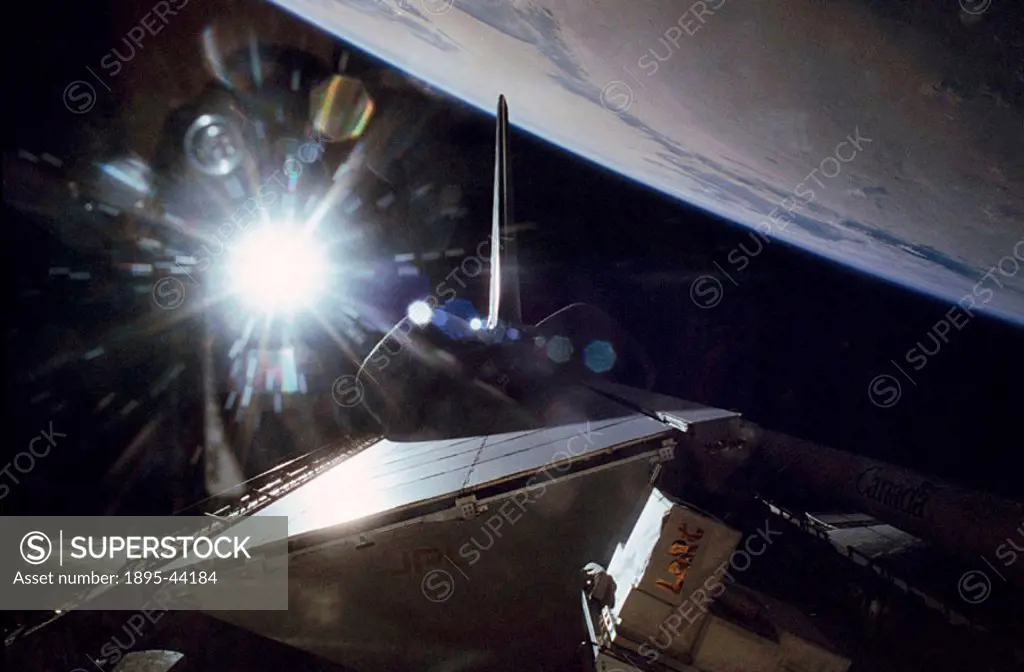 The Sun flares above Endeavour´s payload bay in this view from the STS-68 mission in October 1994. Hardware for the Space Radar Laboratory-2 is partia...