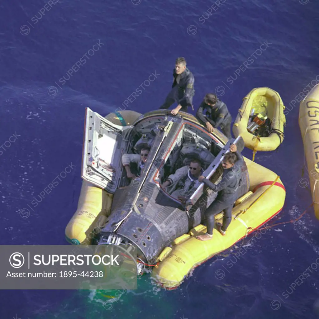 Astronauts Neil Armstrong and David R Scott sit with their spacecraft hatches open while awaiting the arrival of the recovery ship, the USS Leonard F ...