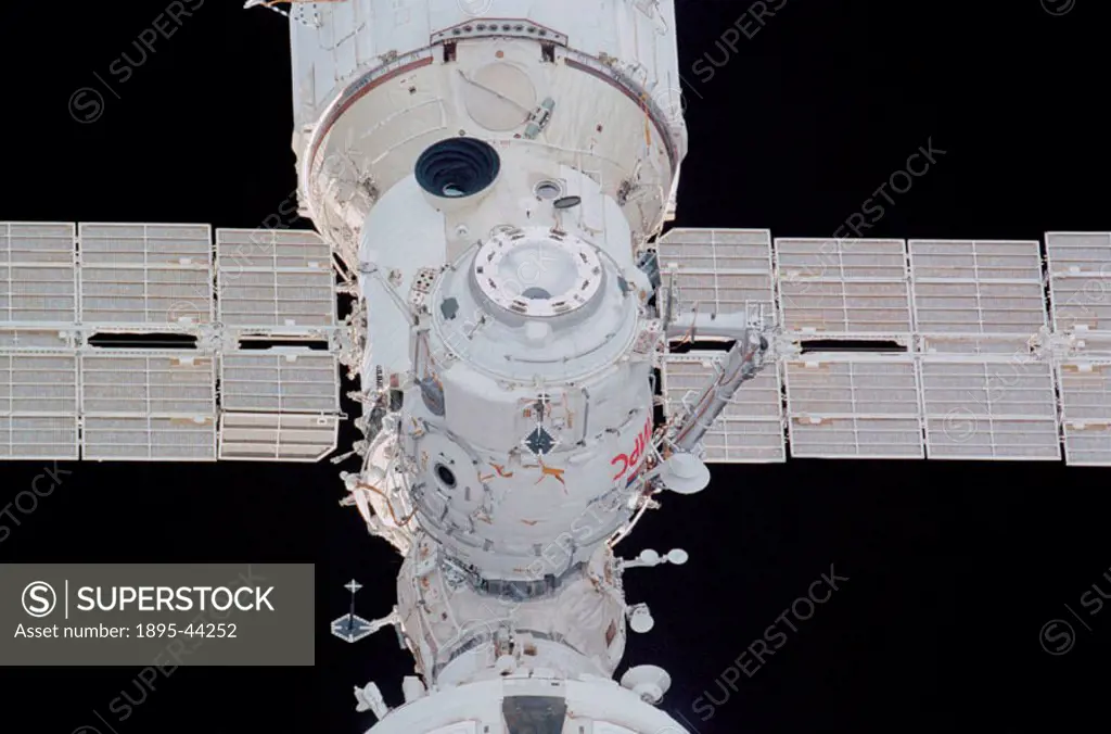 Backdropped by the blackness of space, the Pirs docking compartment on the International Space Station was photographed by a crew member aboard the Sp...