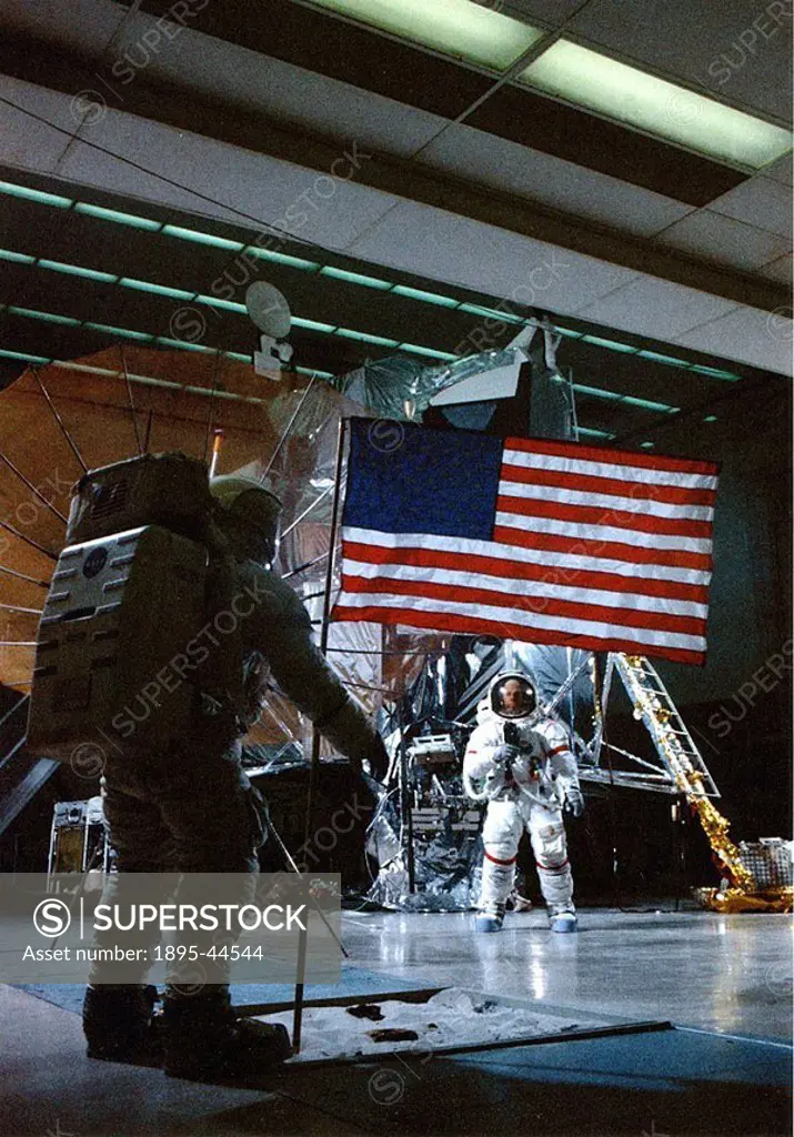 Apollo 14 training, July 1970 Astronaut Al Shepard photographs Ed Mitchell and the flag during indoor EVA extra-vehicular activity training  The S-ban...