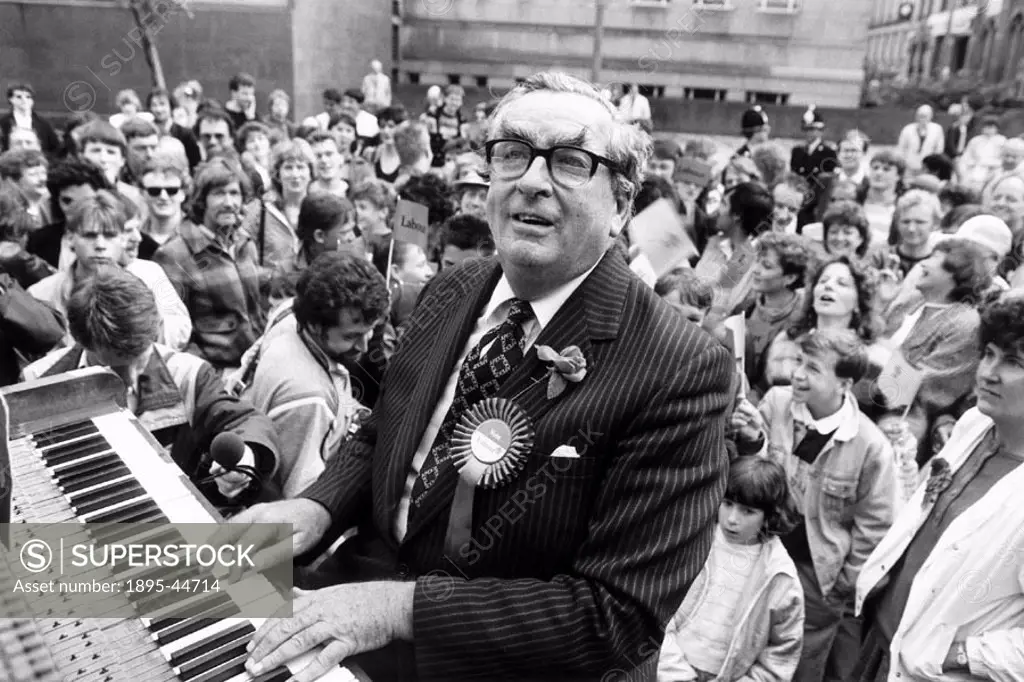 Dennis Healey canvassing votes for the Labour Party by playing the piano at Huddersfield Town Hall, Yorkshire.