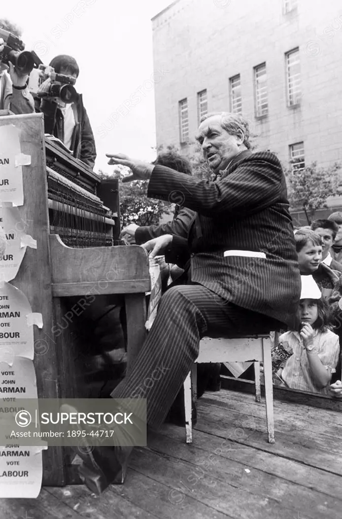 Dennis Healey canvassing votes for the Labour Party by playing the piano at Huddersfield Town Hall, Yorkshire.