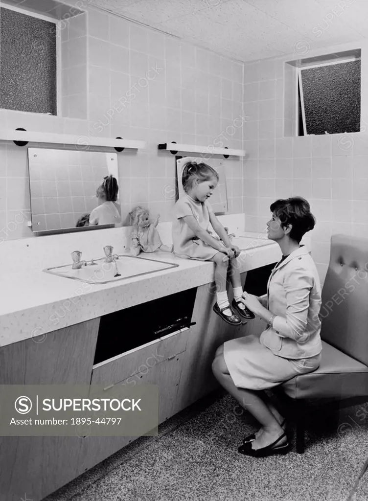 Woman and child in a public lavatory at a Motorail terminal, c 1966 