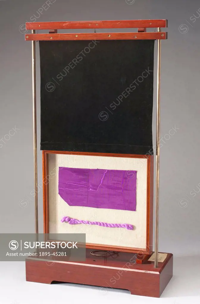 A length of dress fabric and a silk skein both dyed with mauve, mounted in a wooden frame. They were donated by Miss Annie Florence Perkin, daughter o...