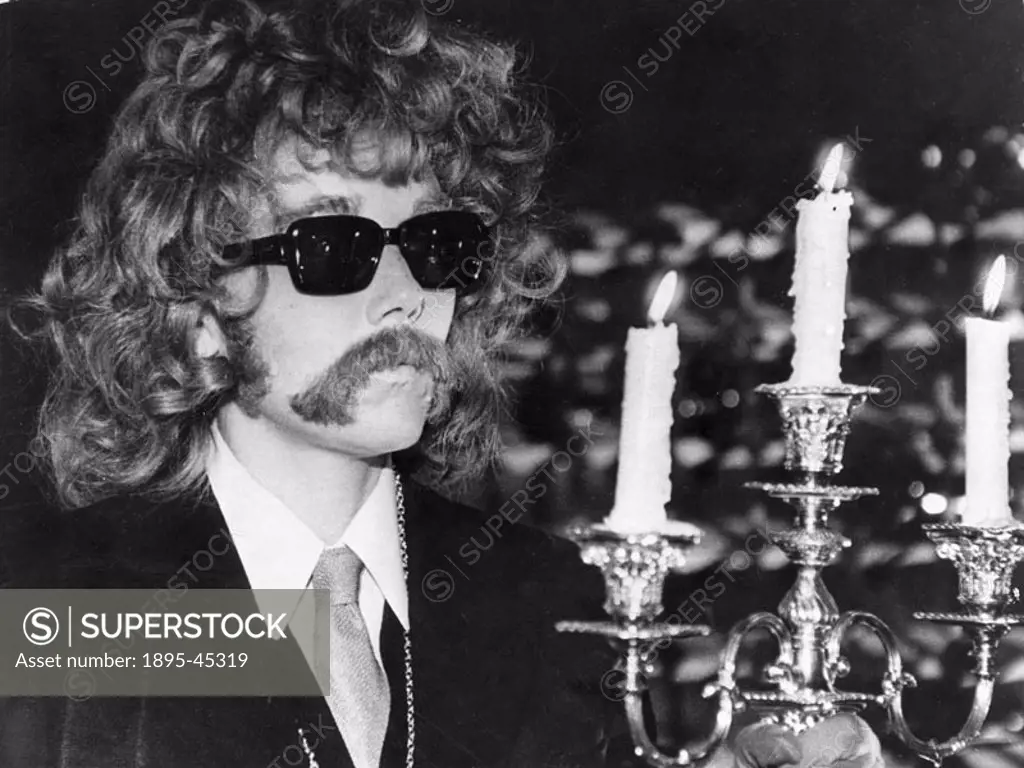 British actress Diana Rigg in false moustache, wig and dark glasses, starring in Theatre of Blood’.