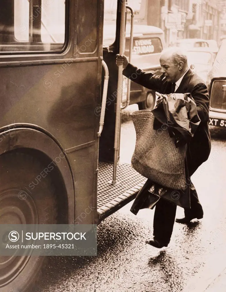 British poet John Betjeman (1906-1984) jumps onto a bus after a court hearing. Betjeman had been held up in a traffic jam and was therefore too late t...