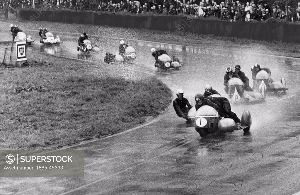 Fritz Scheidegger and John Robinson in the lead at Old Hall corner in a sidecar race.