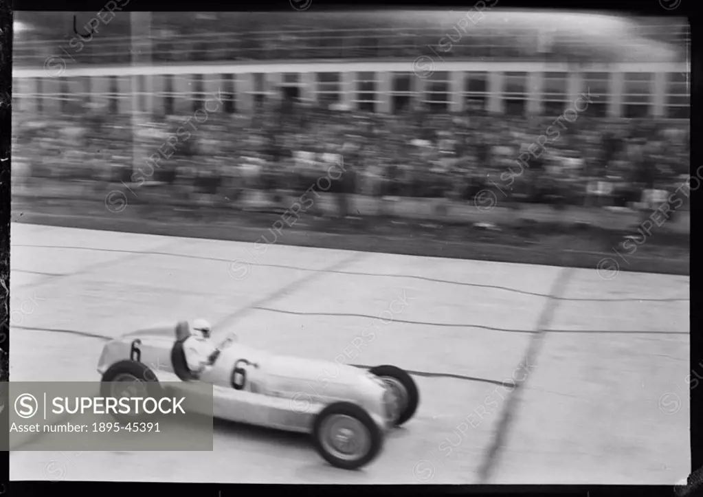 Photograph by Zoltan Glass. Car No 6, a Mercedes-Benz W25 GP being driven by Rudolf Caracciola along the front of the pits.