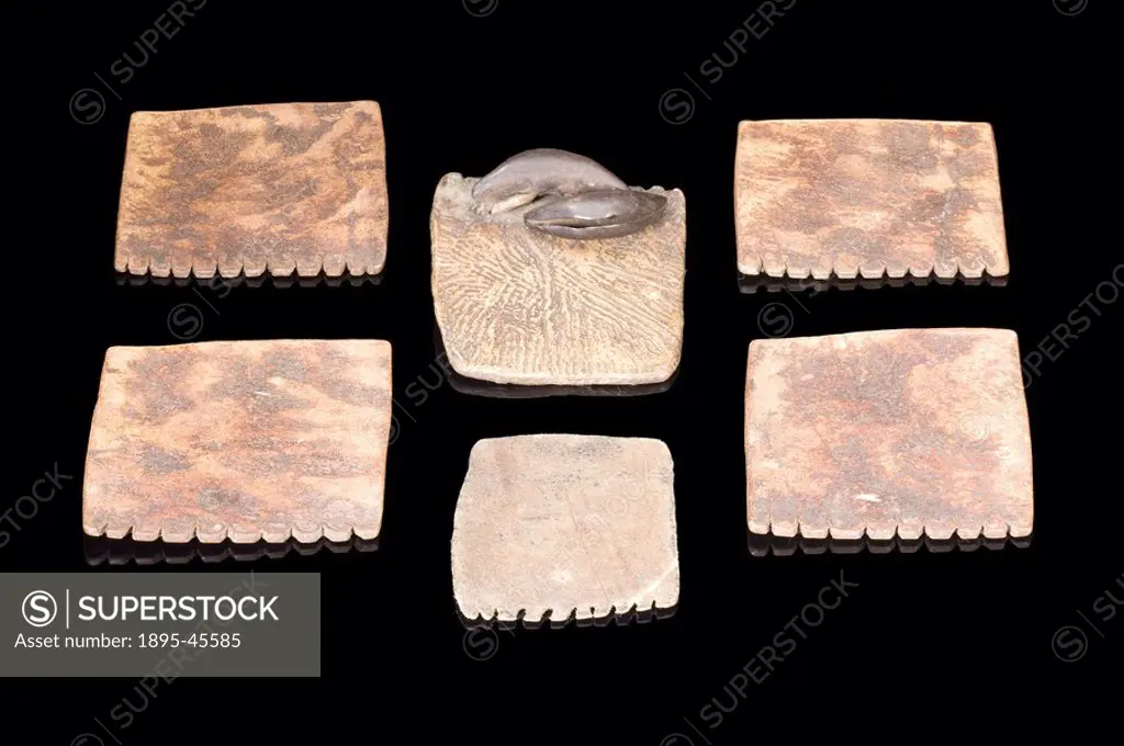 Set of 6 divination plaques made of hide, one with two bells, made by the Baganda people
