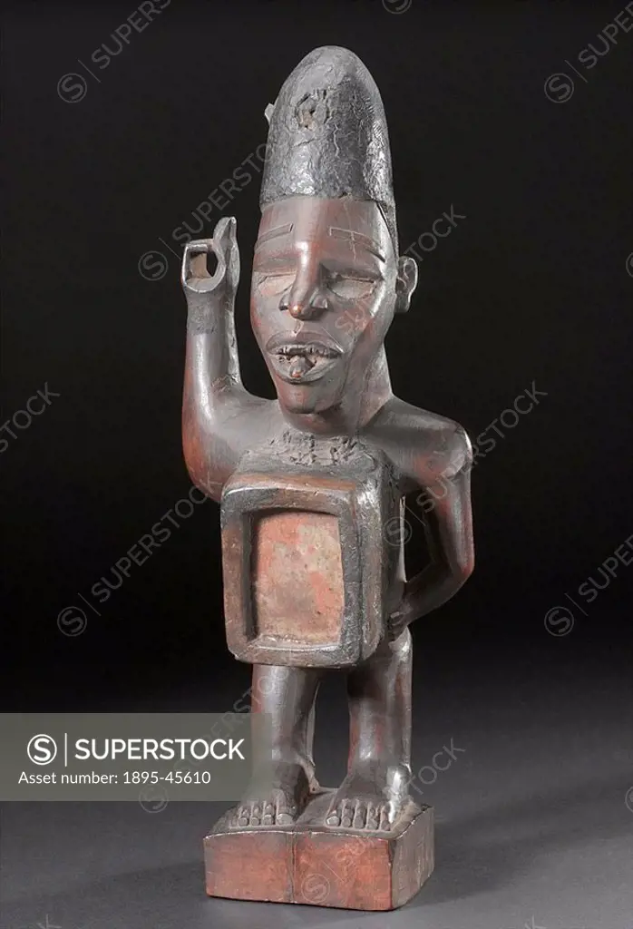 Wooden figure, African, 1890-1910 Carved wooden statue with upraised arm, a container for the nkisi force  Made by the BaKongo people of west-central ...