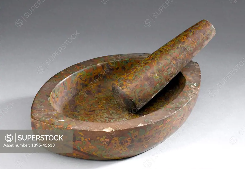 Mortar and pestle of mottled stone. The mortar is ovoid with a flat base, the pestle a tapering cylinder.