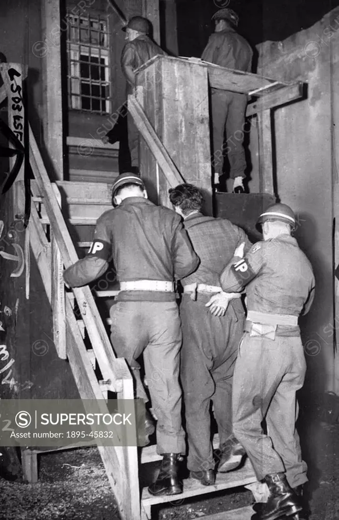 The first of three Germans to be hanged for the murder of a baled-out American airman  Kohn is led up the 13 steps to the gallows by military police