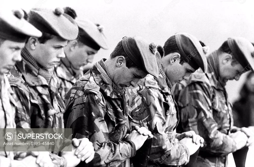 Soldiers from the Scottish Highlanders regiment, bowing their heads at a funeral or memorial service  Britain went to war with Argentina over the Falk...
