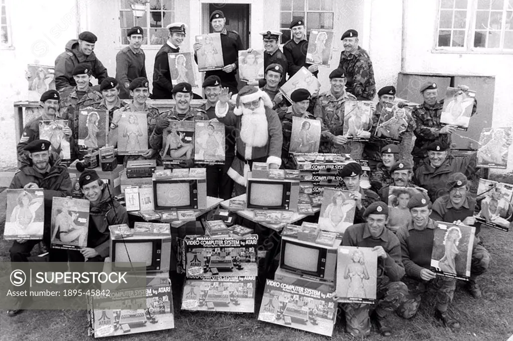 Father Christmas with representatives of British Army units fighting in the Falklands, who recieved gifts which included Atari Video Computer Systems ...