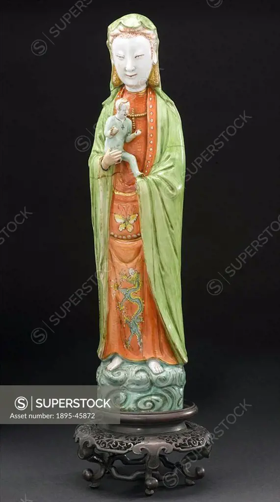 Chinese goddess of maternity Porcelain statue representing a female deity connected with motherhood, on a carved wooden base