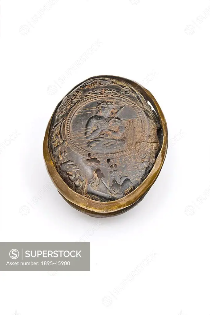 European snuff box, c 1701-1750 An oval snuff box made of horn, bound in brass with a hinged lid, covered with relief illustration