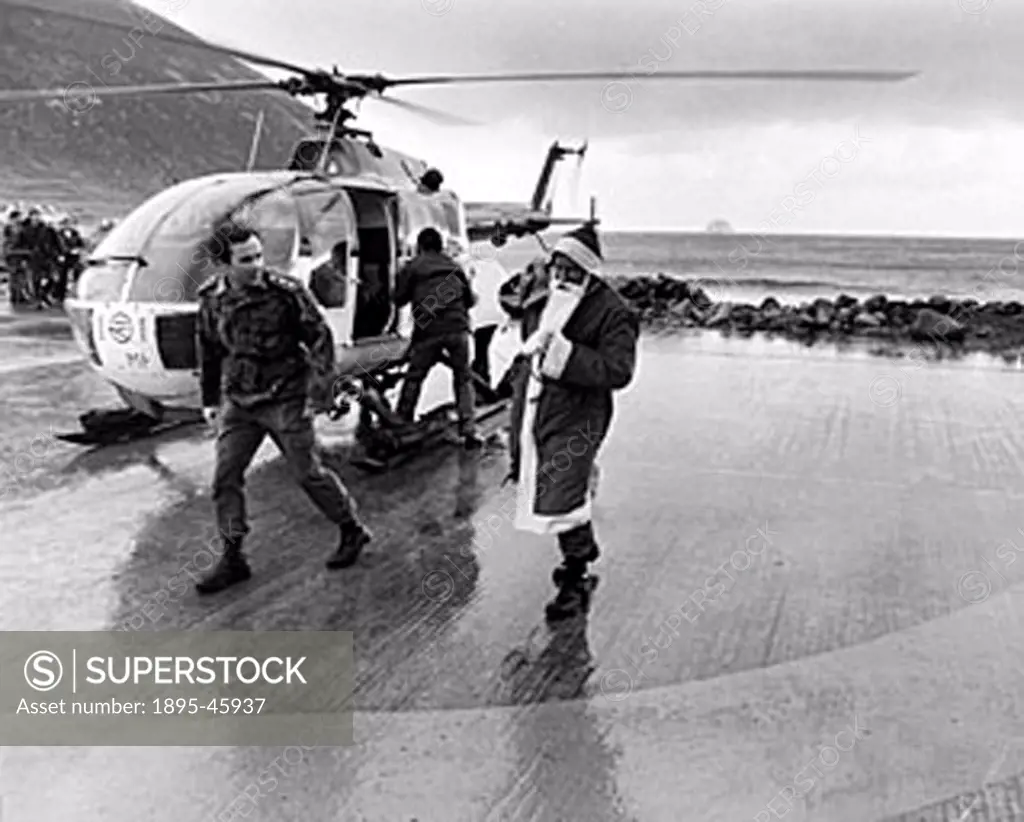 Father Christmas arrives by helicopter to St Kilda, Scotland.