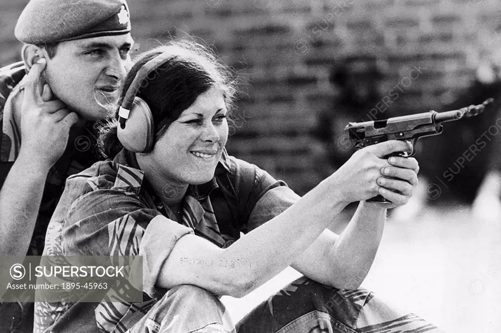A pretty girl learns to shoot under the experienced eye of a Rhodesian Army instructor  Increased guerrilla attacks have meant that women are taking ...