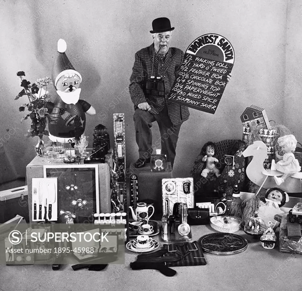 A man offers odds on various Christmas gifts including a walking doll, yard o tweed, feather boa, chocolate box, spinning top, paperweight, mixed spi...