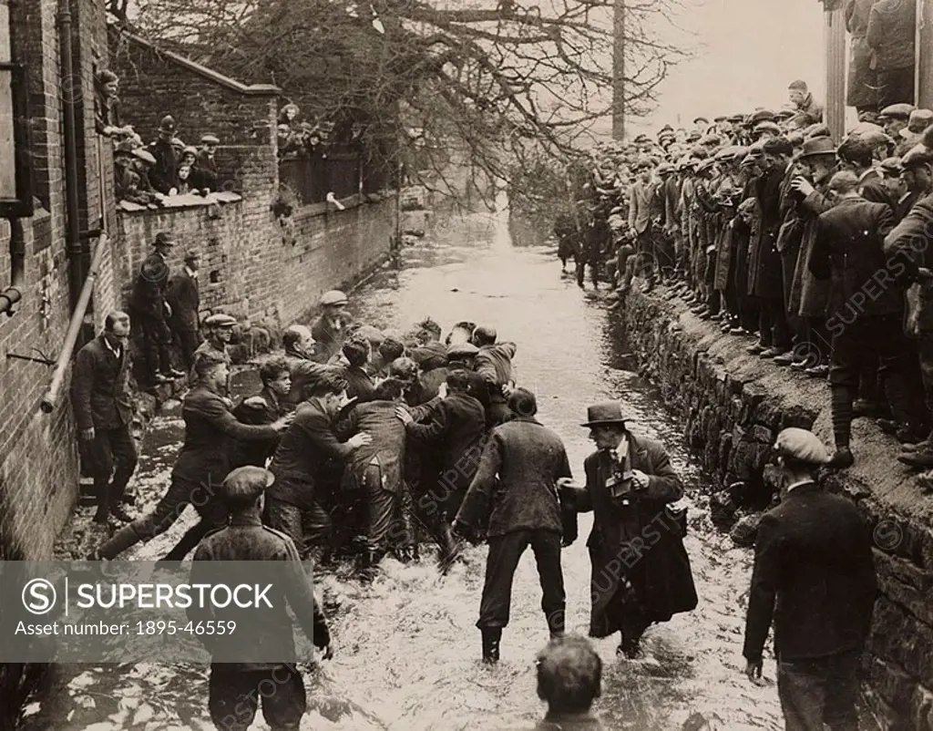 A photograph of players fighting for the ball in Henmore Brook during the Shrovetide football match in Ashbourne, Derbyshire, in 1932  Shrovetide foot...
