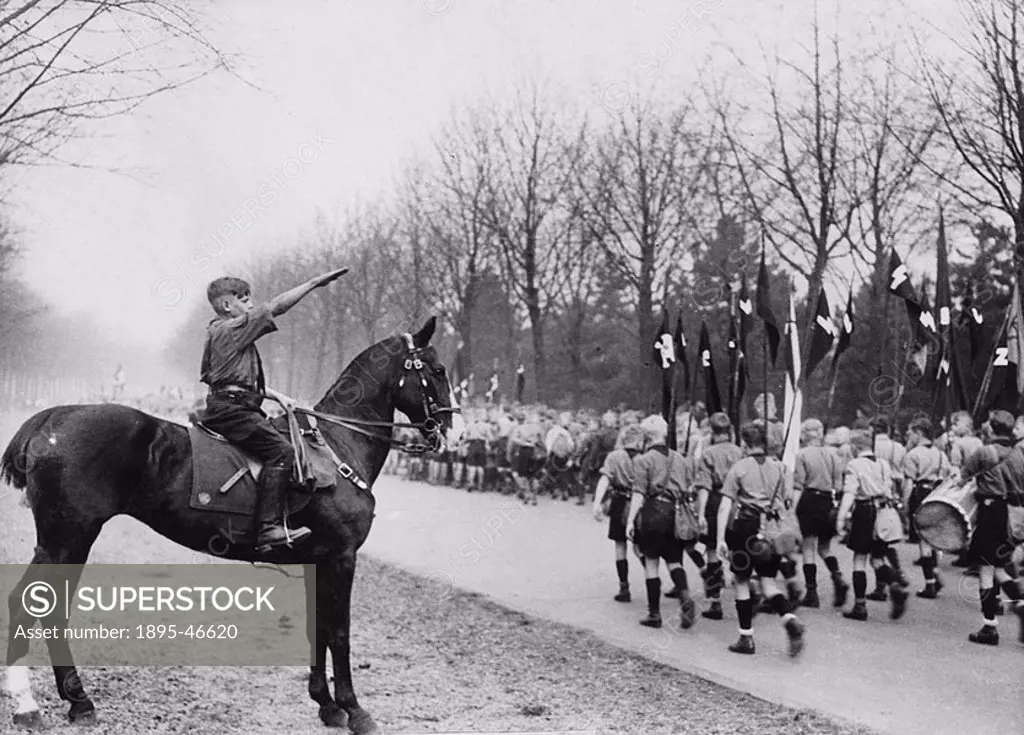 Hitler Youth parade, Hamburg, April 1934 A young Hitlerian on horseback, taking the salute at the march-past of his young comrades at the Hitler Yout...