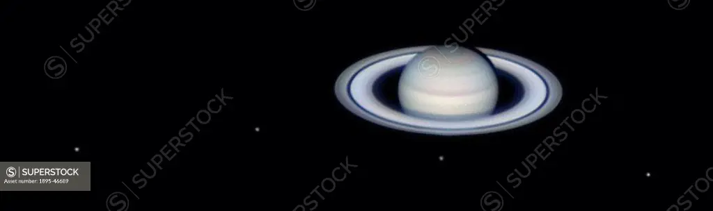 Saturn´s moons, 2004 This image showing Saturn with some of its moons was taken using a webcam attached to a 10-inch Newtonian telescope  The moons ar...