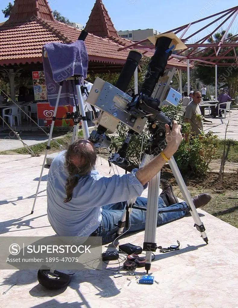 Photographing a total eclipse of the Sun, Turkey, 29 March 2006 Eclipse watcher at the beach near Side in Southern Turkey preparing to observe and pho...