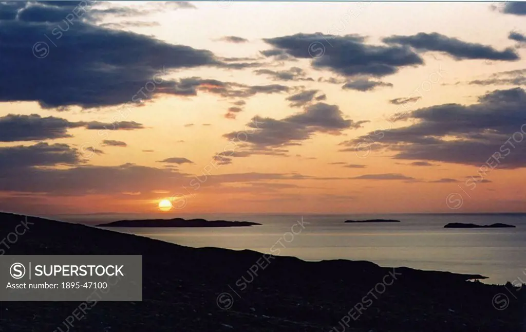 Sunset, 2003 Our own star, the Sun, is seen setting over the sea off the northwest coast of Scotland  Photograph by Jamie Cooper