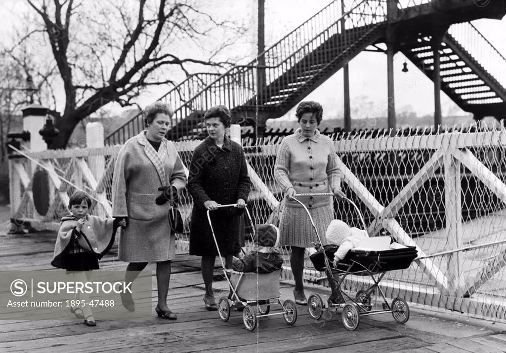 Women walking over a level crossing, Earby, Lancashire, April 1968 Level crossing controversy - women protesters walking on the crossing to get to th...
