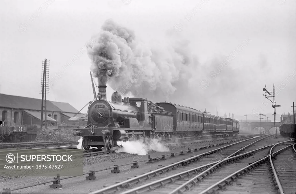 Caledonian Railway steam locomotive and passenger trainCR 4-4-0, locomotive number 14382 pulling a passenger train 