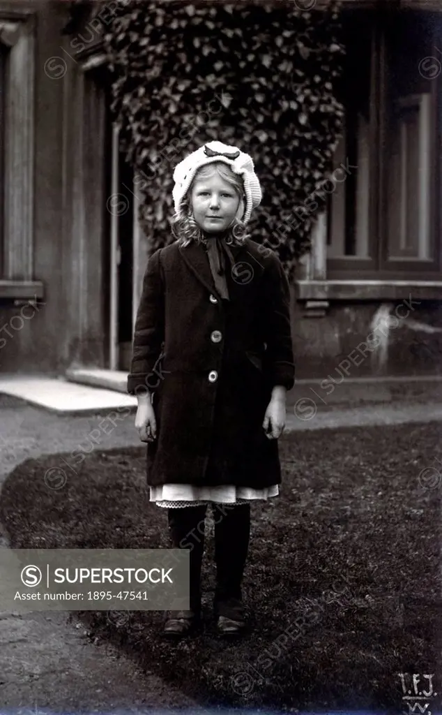 Girl in winter clothing, 1900s Edwardian portrait of a girl in a knitted bonnet, coat and gaiters over her boots 