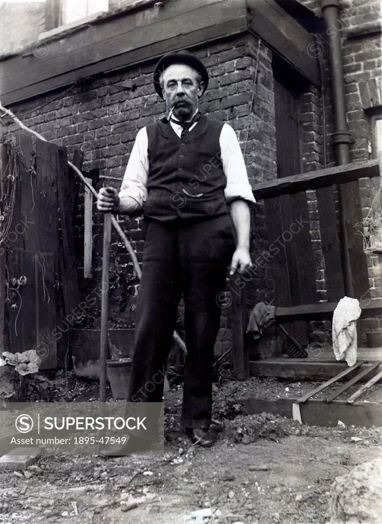 Man in back yard, c early 20th century 