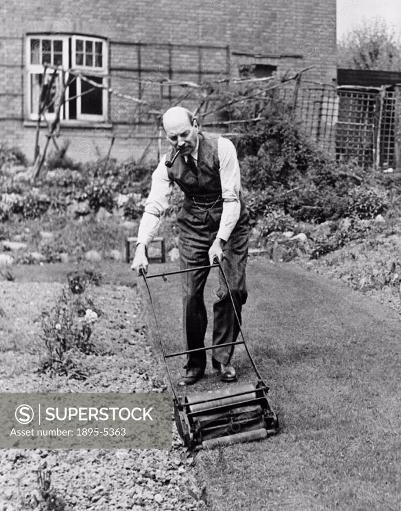 Attlee, Britain´s deputy prime minister at the time, cutting the lawn at his home in Stanmore, Essex. Photograph by James Jarche.