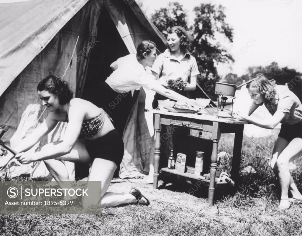 Four women outside a tent during their camping holiday, c 1930s.