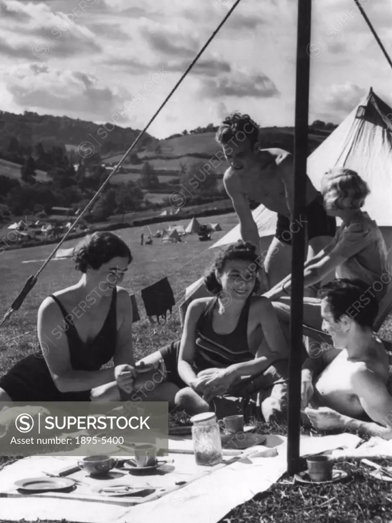 ´After a swim, a cup of tea for holiday makers in camp at Branscombe, South Devon.´